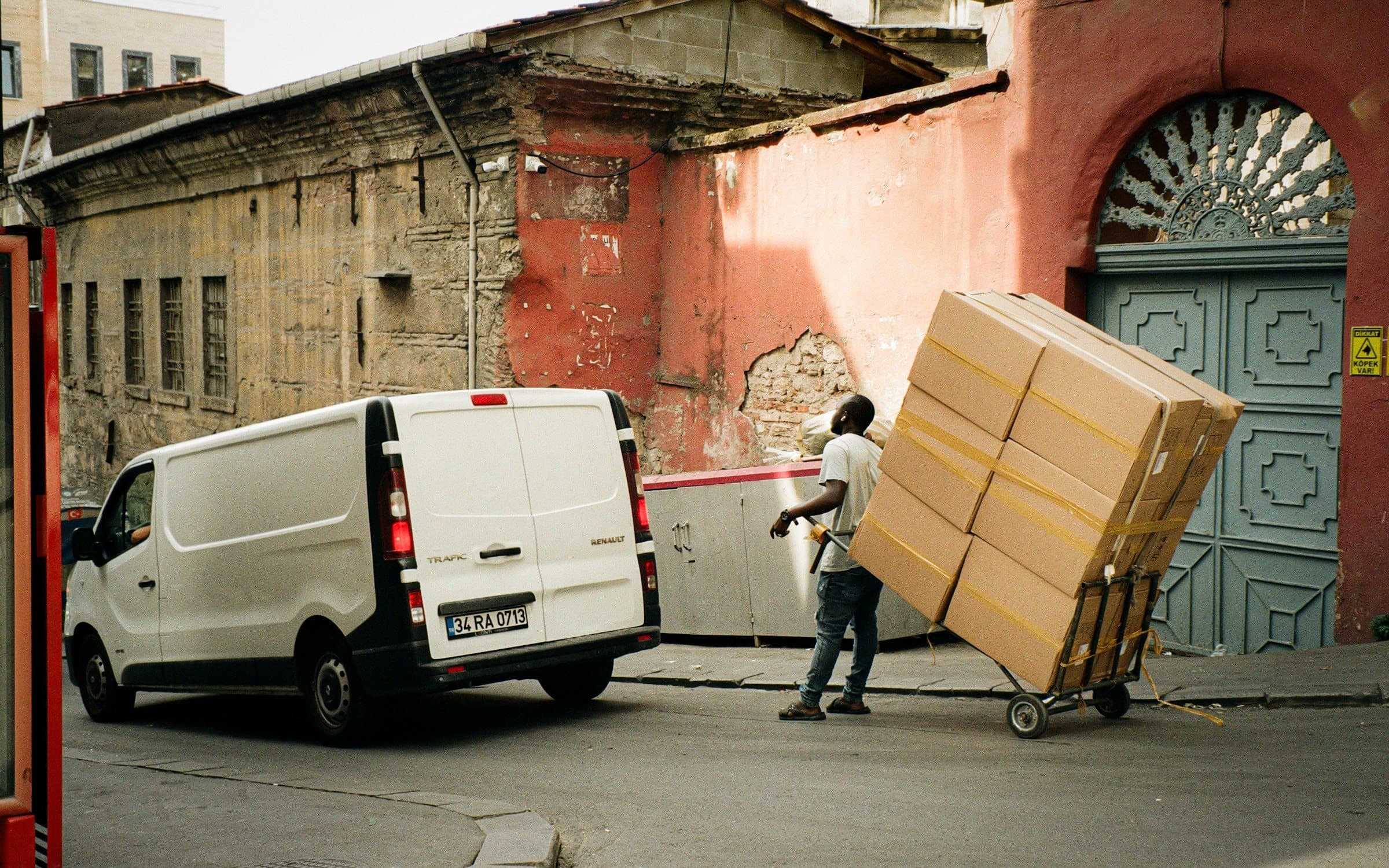 Mover from Apple Logistics wheeling packed cartons to a loading van during a house shifting in Chandigarh