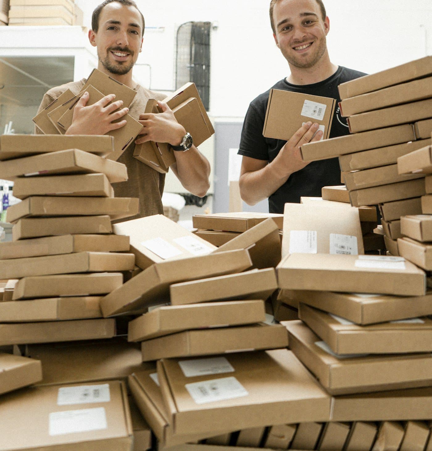 Two packers preparing cardboard cartons for household packing