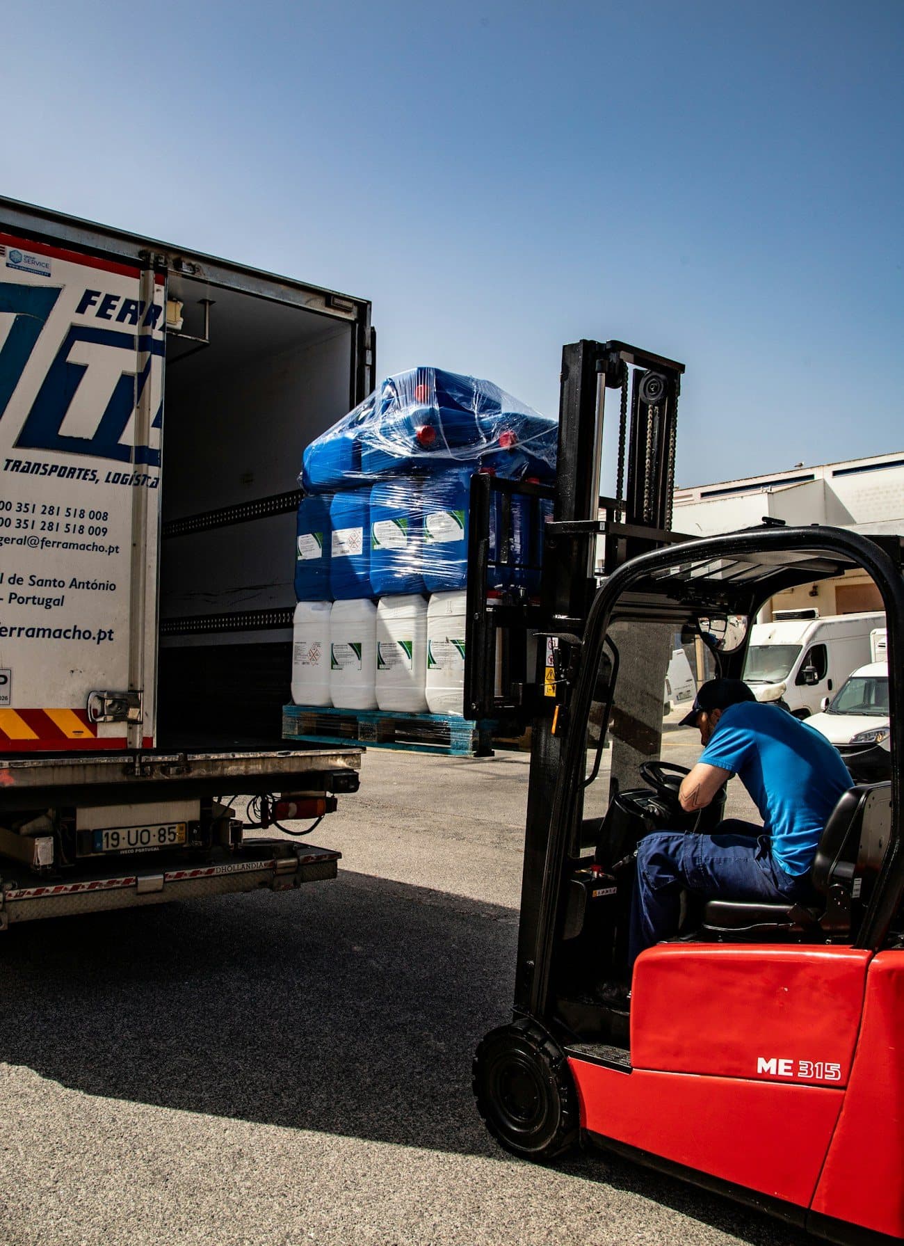Heavy industrial machinery and plant manufacturing equipment securely crated and loaded onto low-bed trailers for factory relocation in Baddi