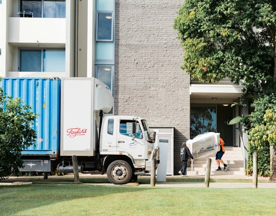 Moving truck being loaded with furniture outside a residential building